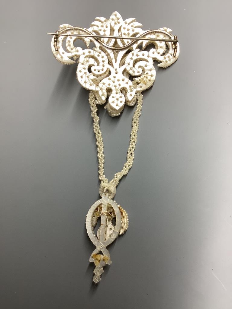A 19th century seed pearl encrusted drop brooch in fitted box, 13.9 cm.